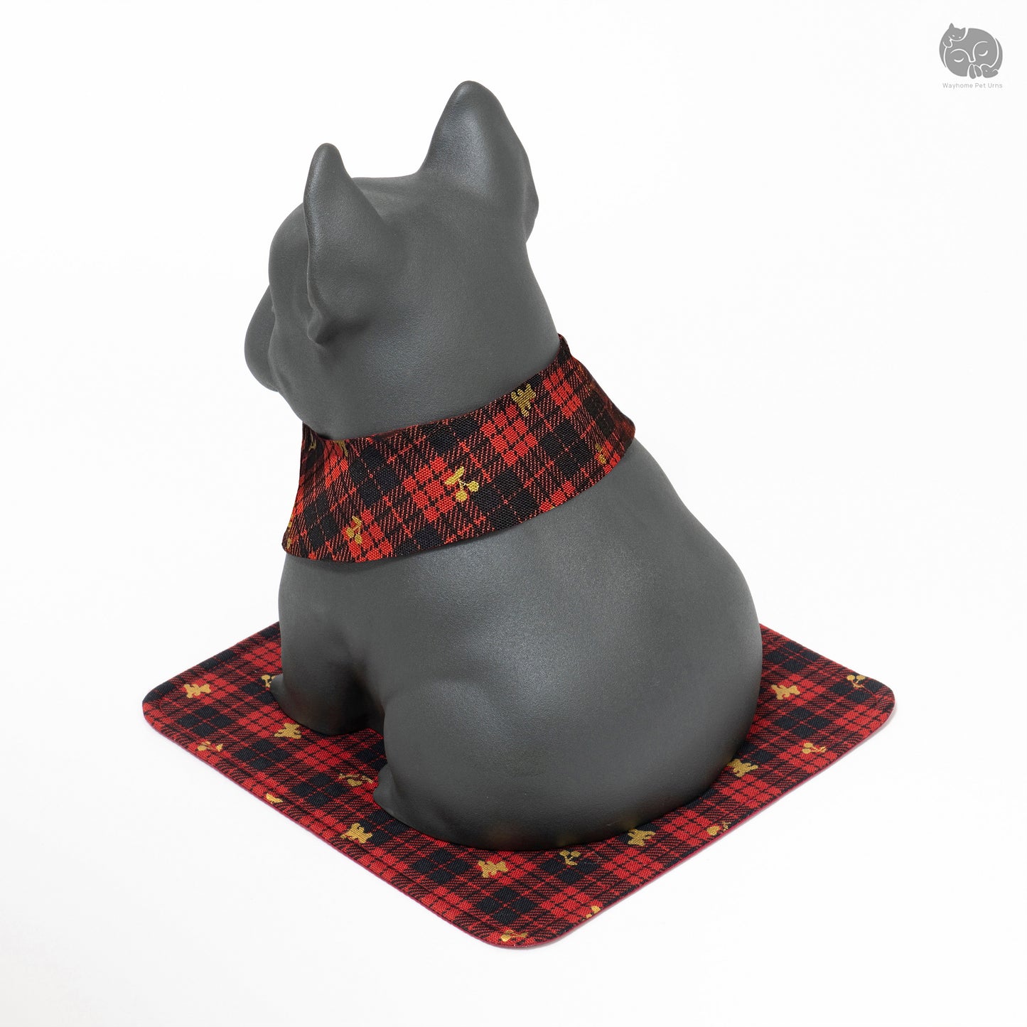 Rear quarter view of the black dog urn, highlighting the sturdy base and decorative red plaid mat.