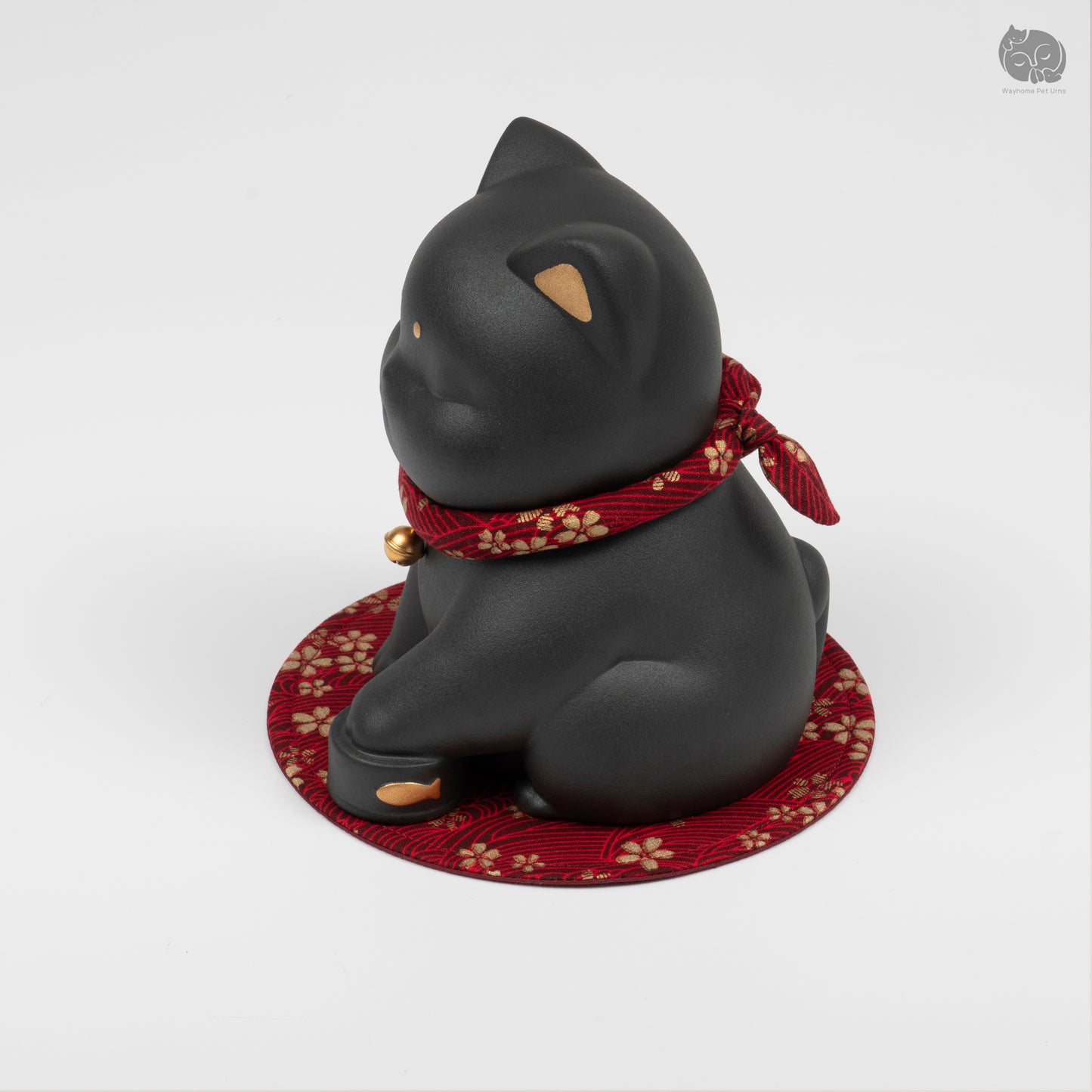 Angled side view of the black ceramic cat urn, highlighting the peaceful artisan sculpture.