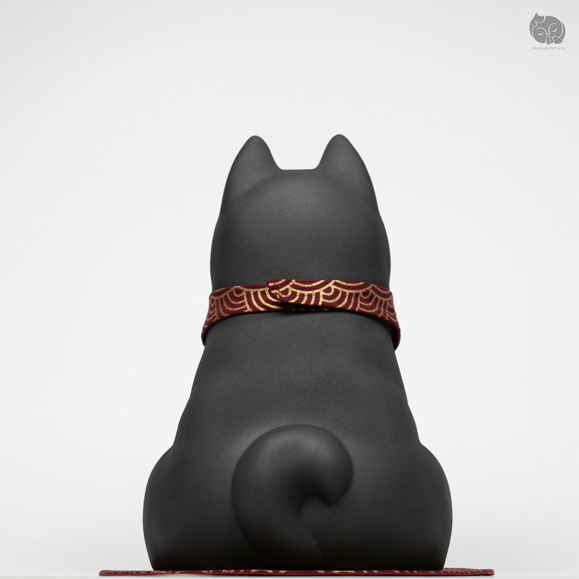Back view of the Wayhome black dog memorial jar, highlighting the smooth ceramic finish and curled tail detail.