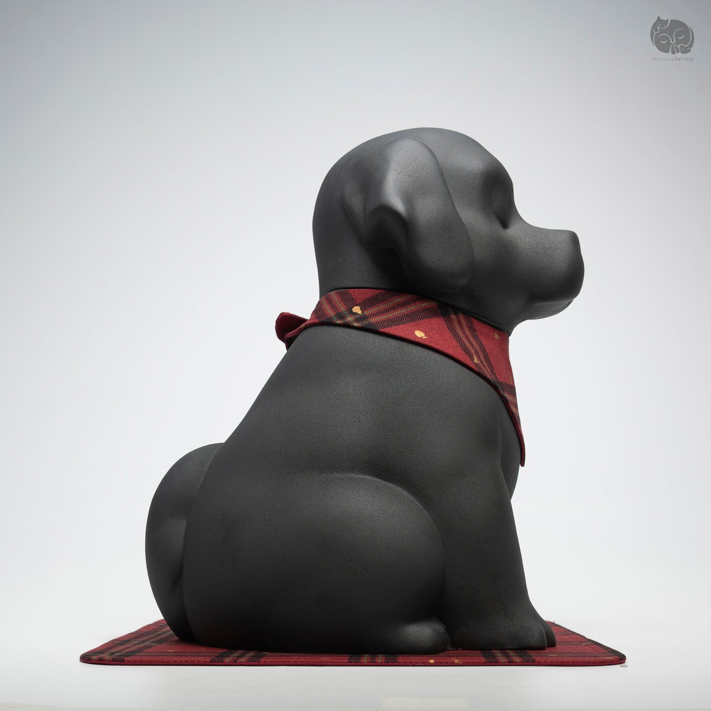 Side profile of the handcrafted black ceramic dog memorial jar, showing its sturdy and dignified silhouette.