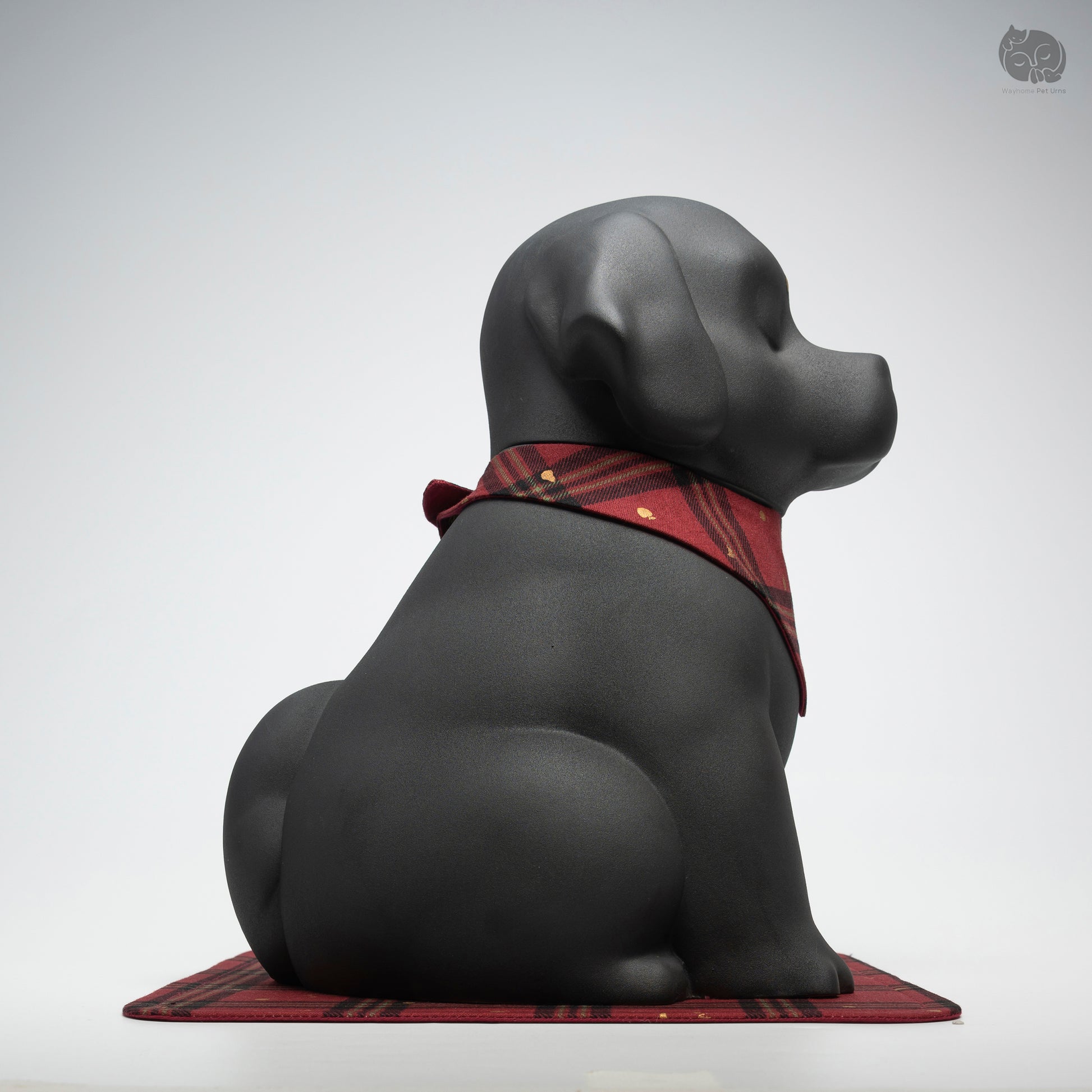Side profile of the handcrafted black ceramic dog memorial jar, showing its sturdy and dignified silhouette.