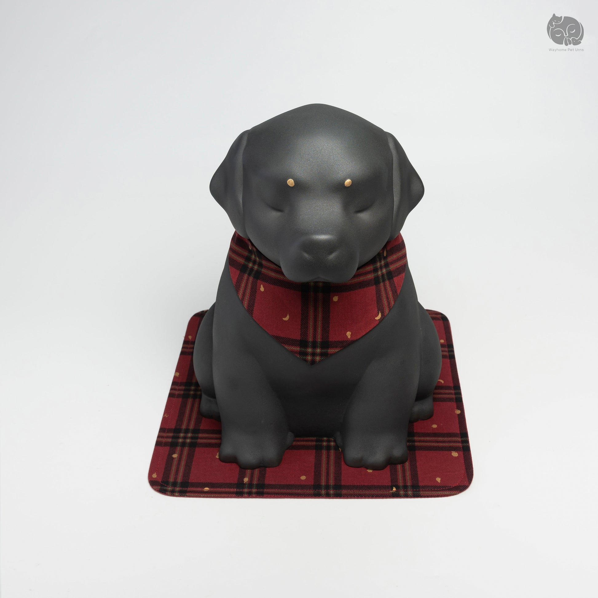 Top-down front view of the obsidian black ceramic dog urn, showing peaceful facial expression and golden eye details.