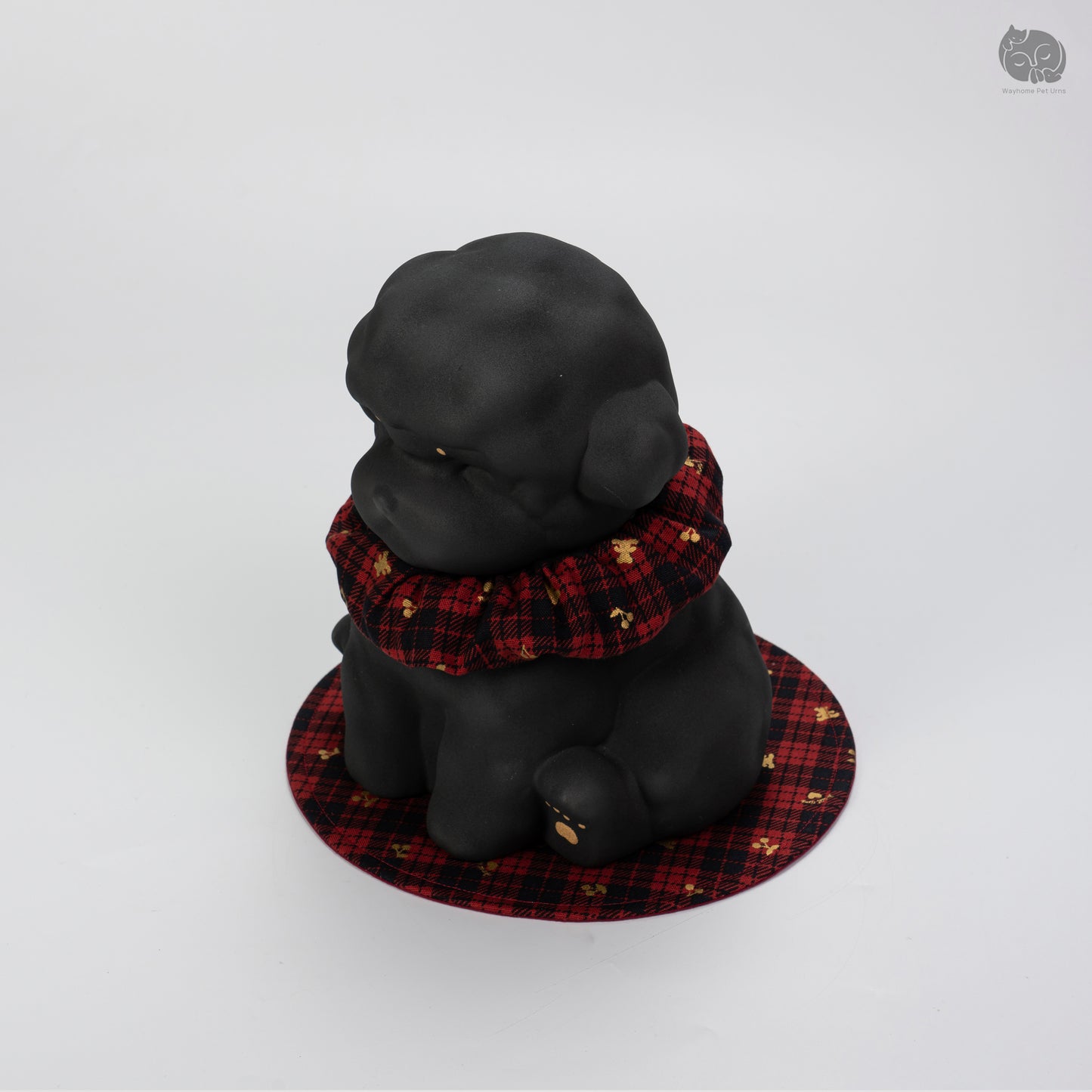 Rear quarter view of the obsidian black dog urn, highlighting the calm expression and sturdy handcrafted ceramic base.