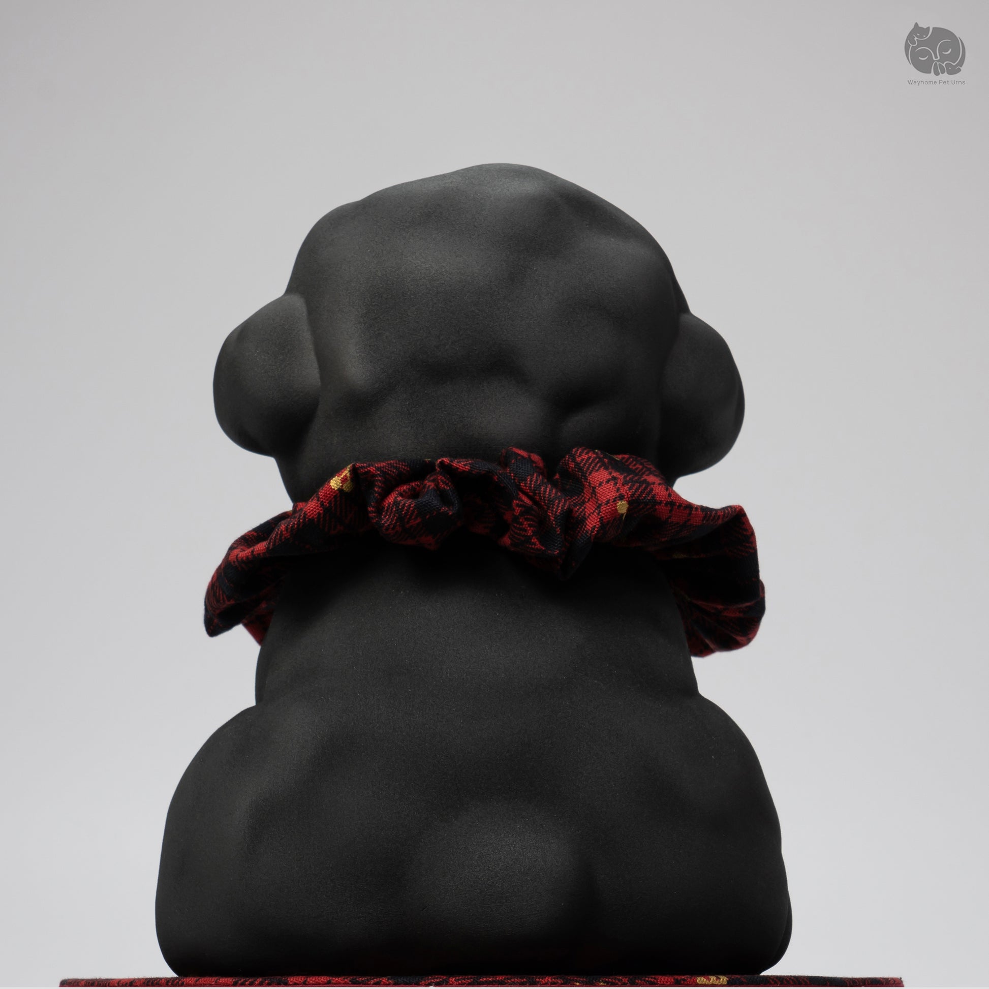 Side profile of the handcrafted black ceramic dog memorial jar, showing the curly fur texture for Teddy breeds.