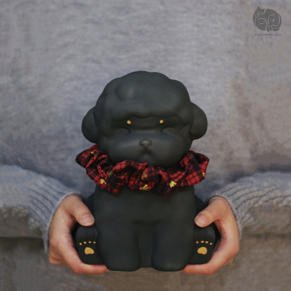 Wayhome obsidian black ceramic dog urn for Poodle and Bichon, held in hands to show actual size and matte texture.