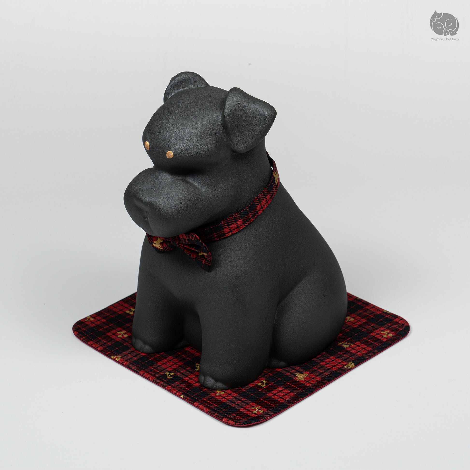 Front quarter view of the handcrafted black Terrier memorial keepsake, featuring the elegant red plaid bow tie.