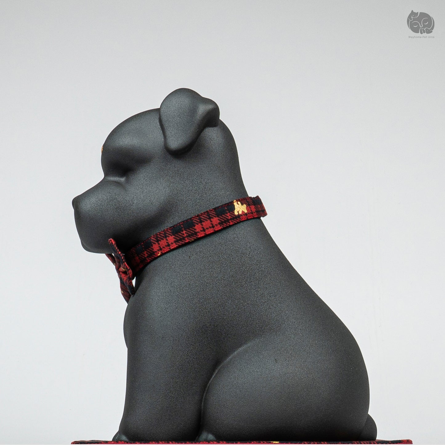 Side profile of the handcrafted black ceramic dog memorial jar, showing the unique artistic Terrier silhouette.