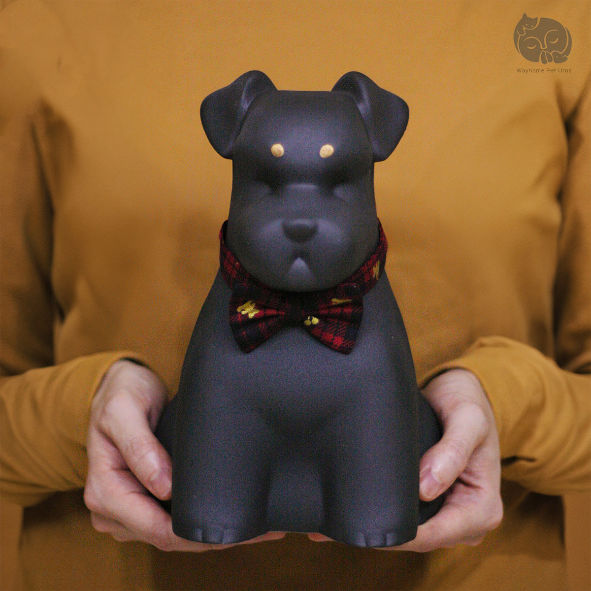 Wayhome obsidian black ceramic dog urn for Terriers held in hands to show actual size and premium matte finish.