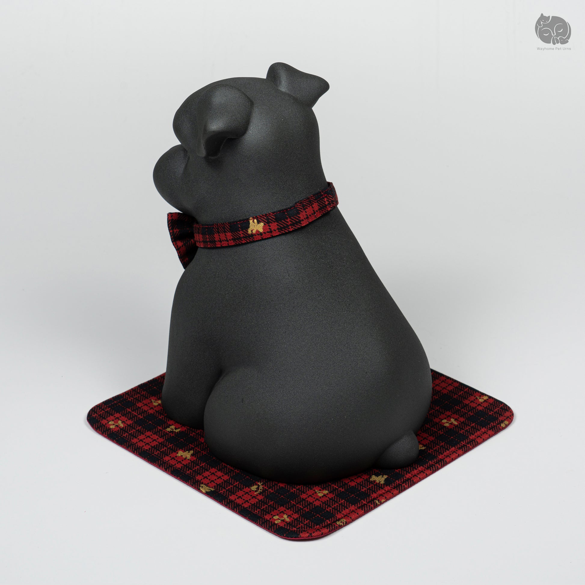 Rear quarter view of the obsidian black Terrier memorial jar, highlighting the peaceful expression and handcrafted ears.