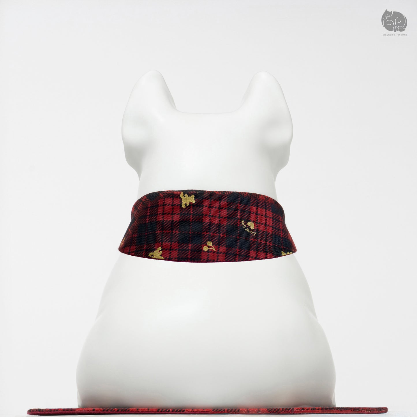 Back view of the Wayhome ivory white ceramic keepsake urn on a traditional red plaid mat.