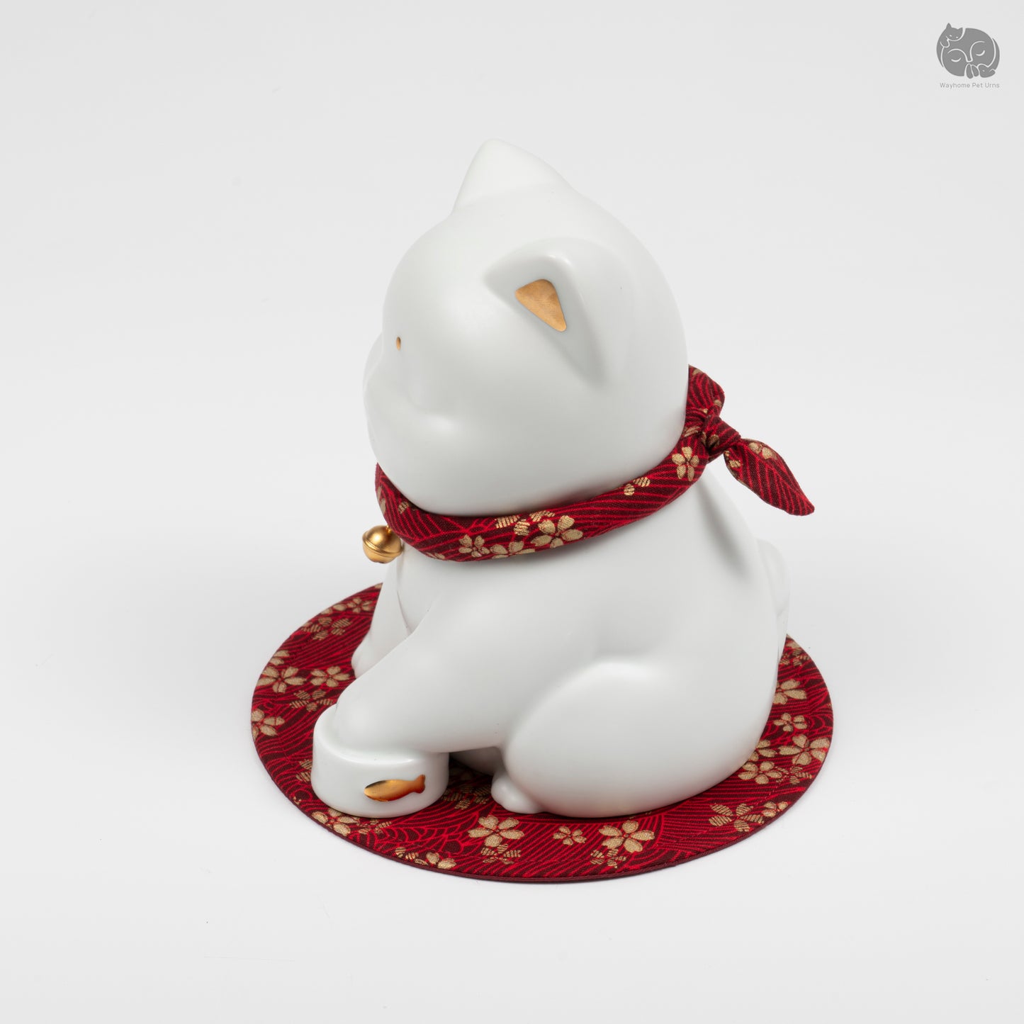 Angled side profile of the ivory white ceramic cat urn, highlighting the peaceful artisan sculpture.