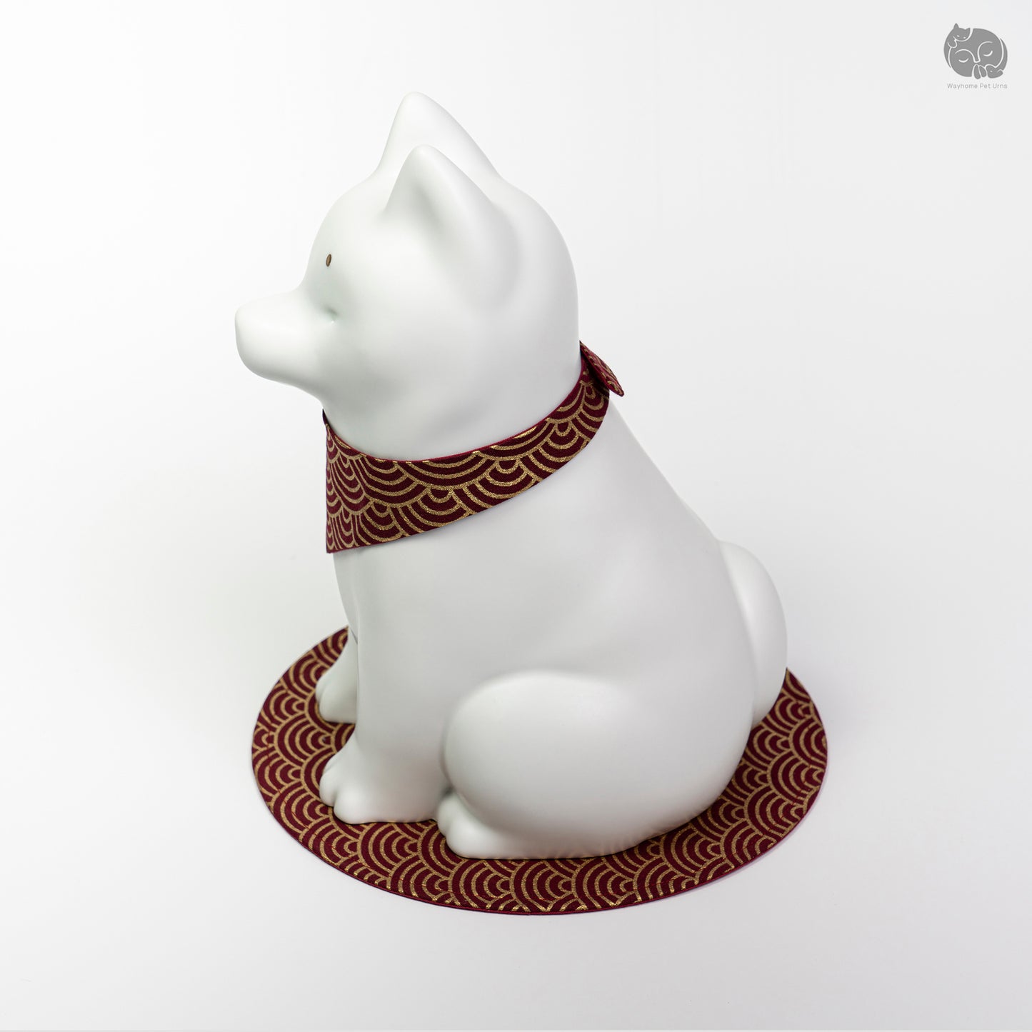 Angled side view of the ivory white ceramic dog urn, highlighting the peaceful artisan sculpture.