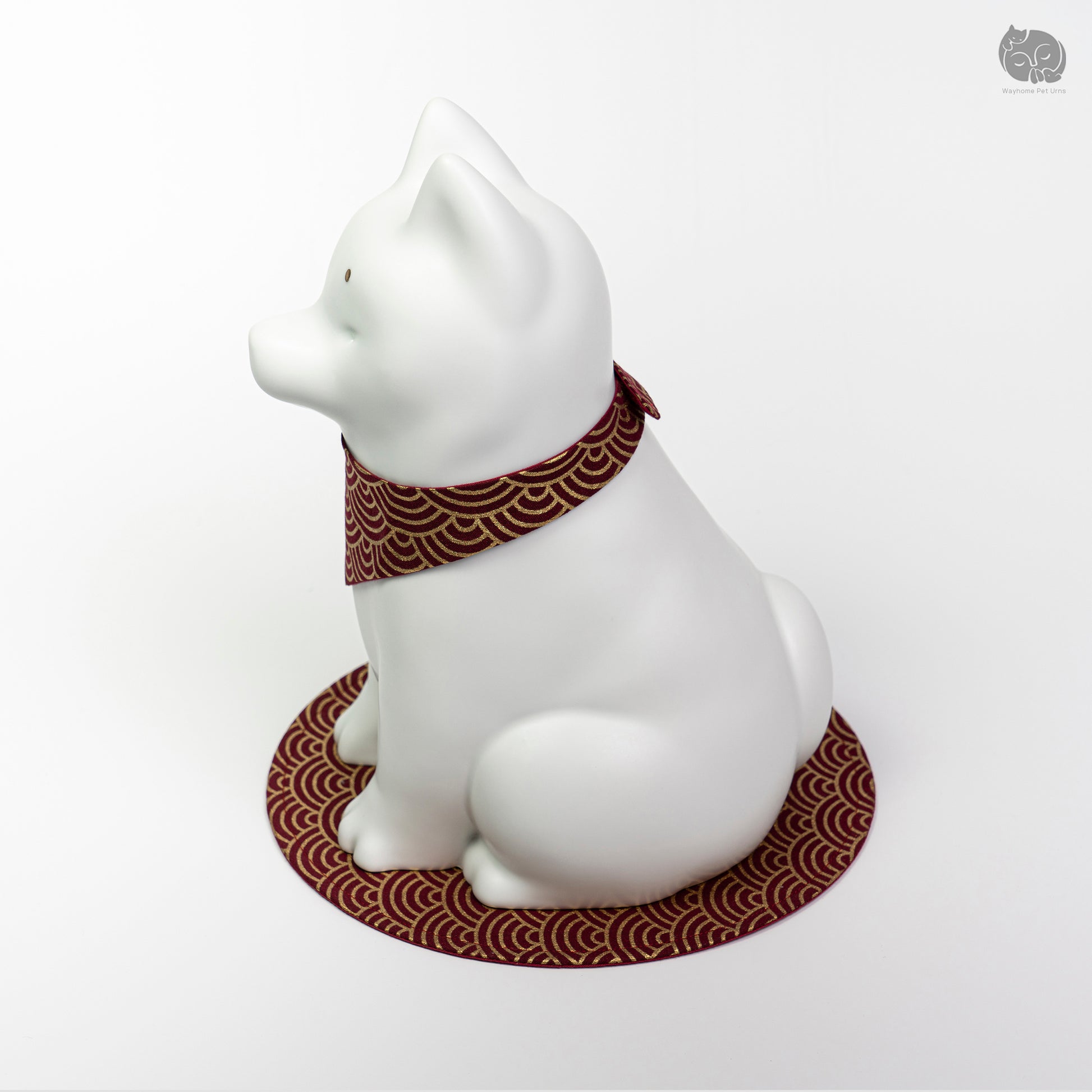 Angled side view of the ivory white ceramic dog urn, highlighting the peaceful artisan sculpture.