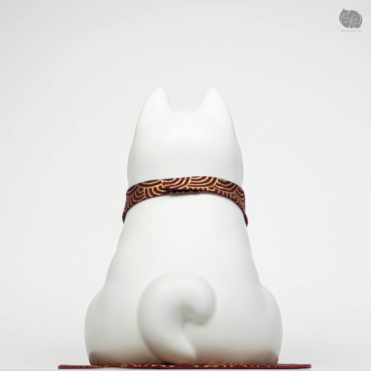 Back view of the Wayhome white dog memorial jar, highlighting the smooth ceramic finish and curled tail detail.