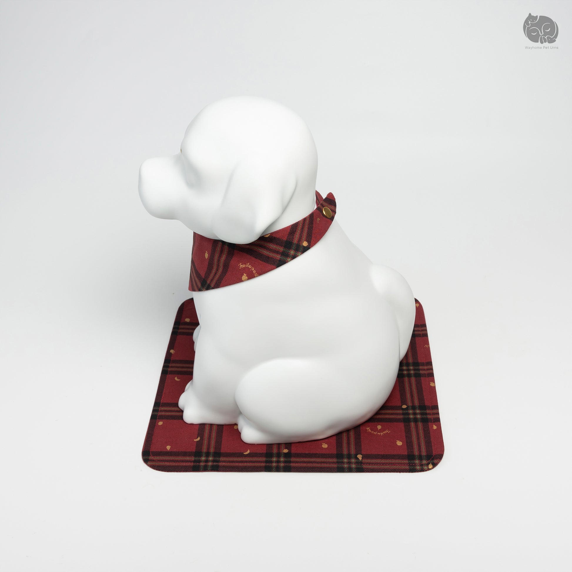 Angled top view of the ivory white ceramic dog urn, showing peaceful facial expression and secure handcrafted base.