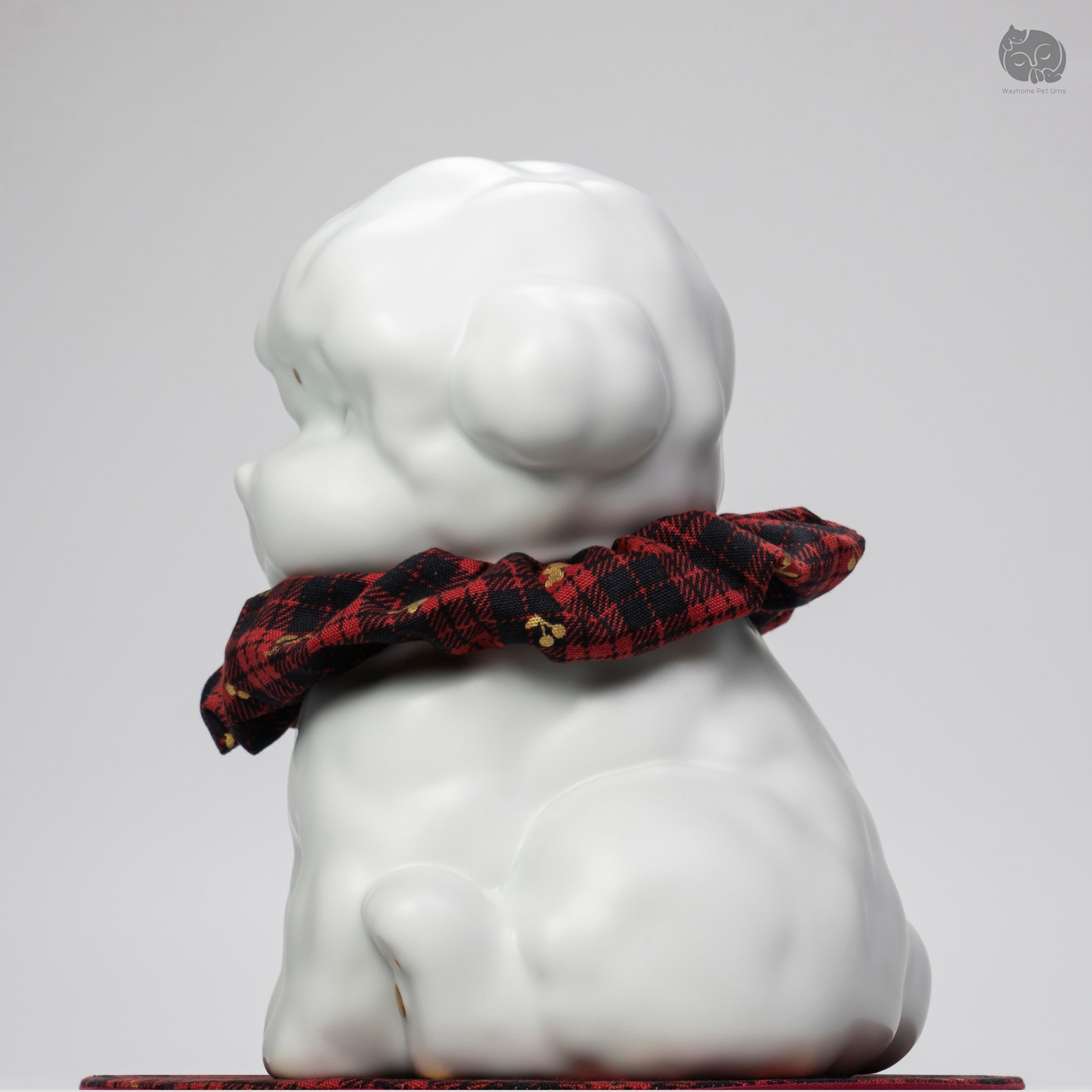 Side profile of the handcrafted white ceramic dog memorial jar, showing the curly fur texture for Teddy breeds.