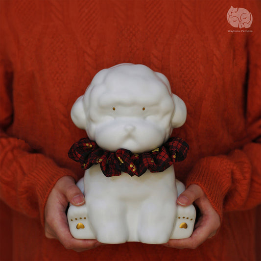Wayhome ivory white ceramic dog urn for Poodle and Bichon, held in hands to show actual size and artisan texture.