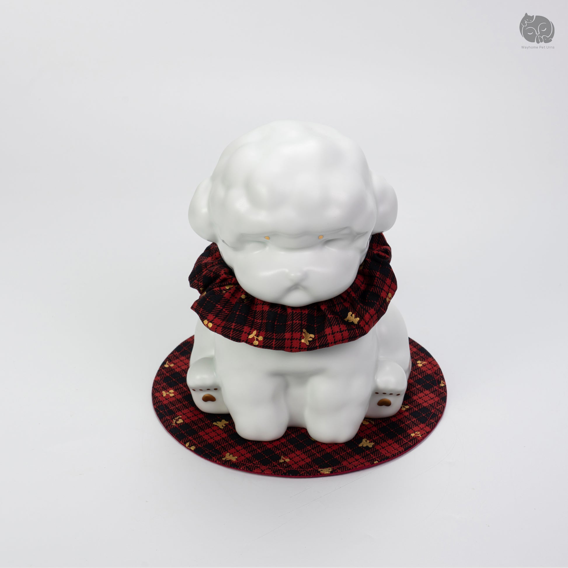 Top-down front angle of the Wayhome white poodle urn, highlighting the peaceful artisan face and golden eye details.