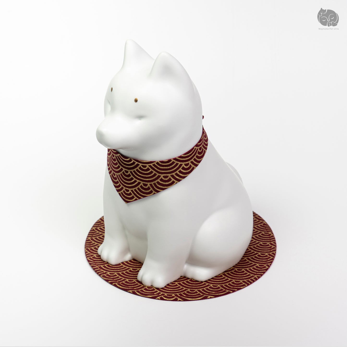 Front angle view of the ivory white ceramic dog urn on a red mat, perfect for a memorial altar for a Shiba Inu.