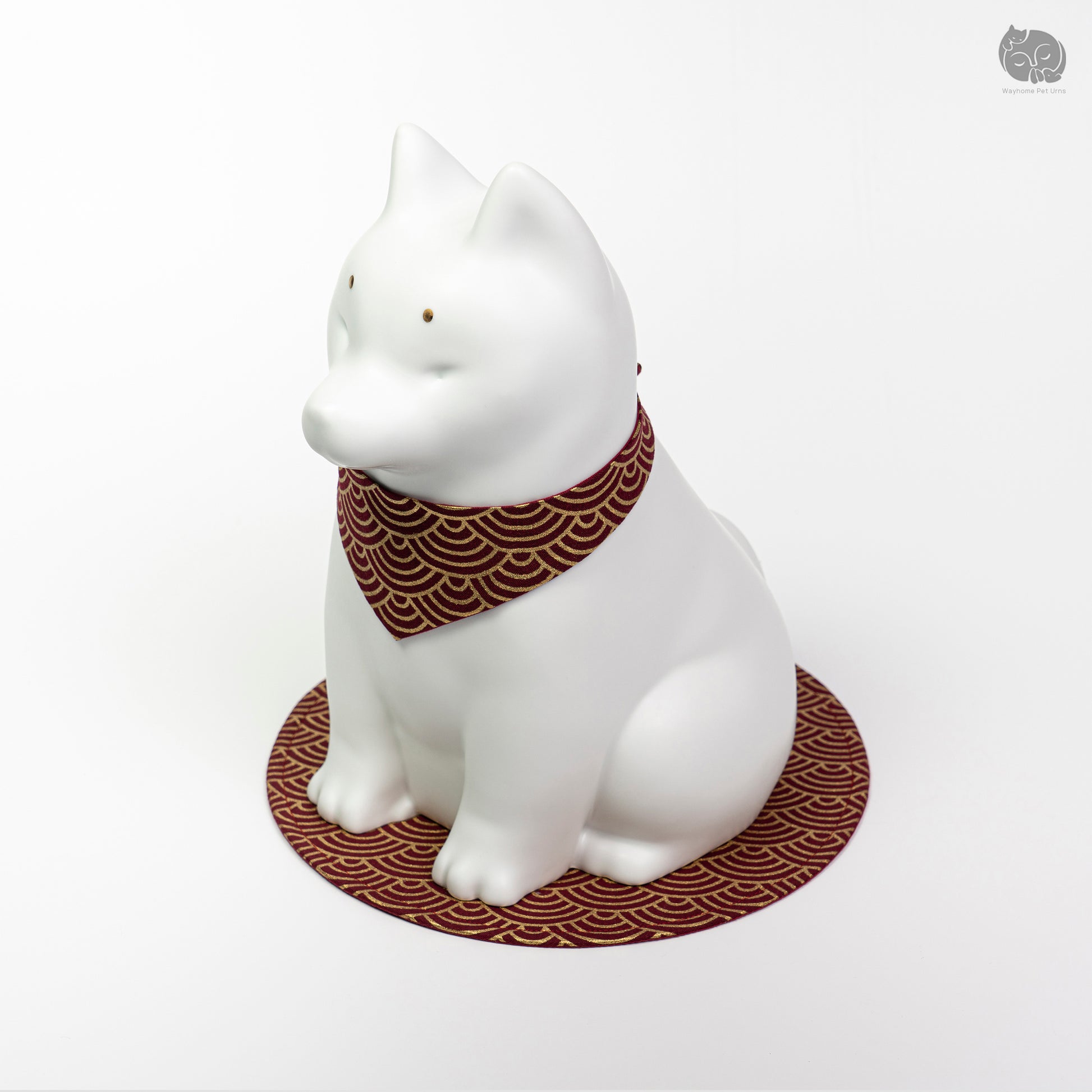 Front angle view of the ivory white ceramic dog urn on a red mat, perfect for a memorial altar for a Shiba Inu.