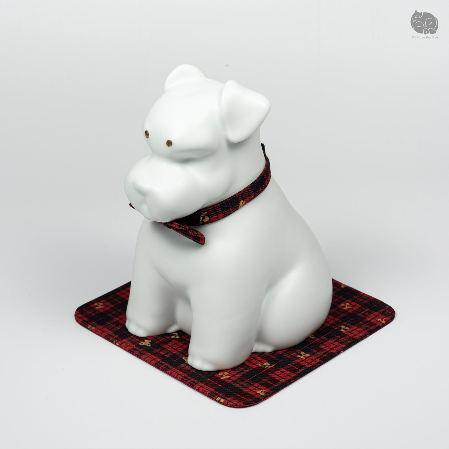 Angled front view of the handcrafted white ceramic dog memorial jar, showing the unique Terrier silhouette.