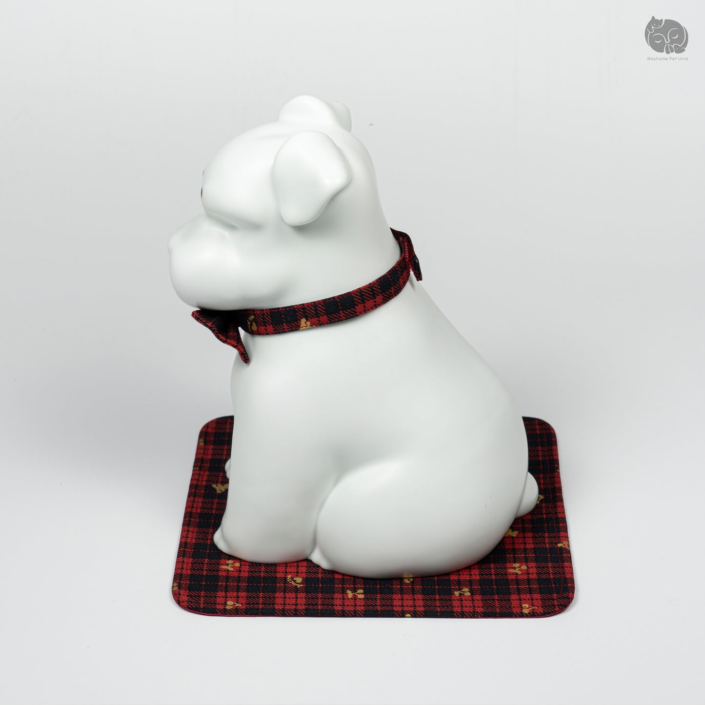 Side profile of the Wayhome white Terrier keepsake urn, highlighting the smooth ceramic finish and bow tie detail.