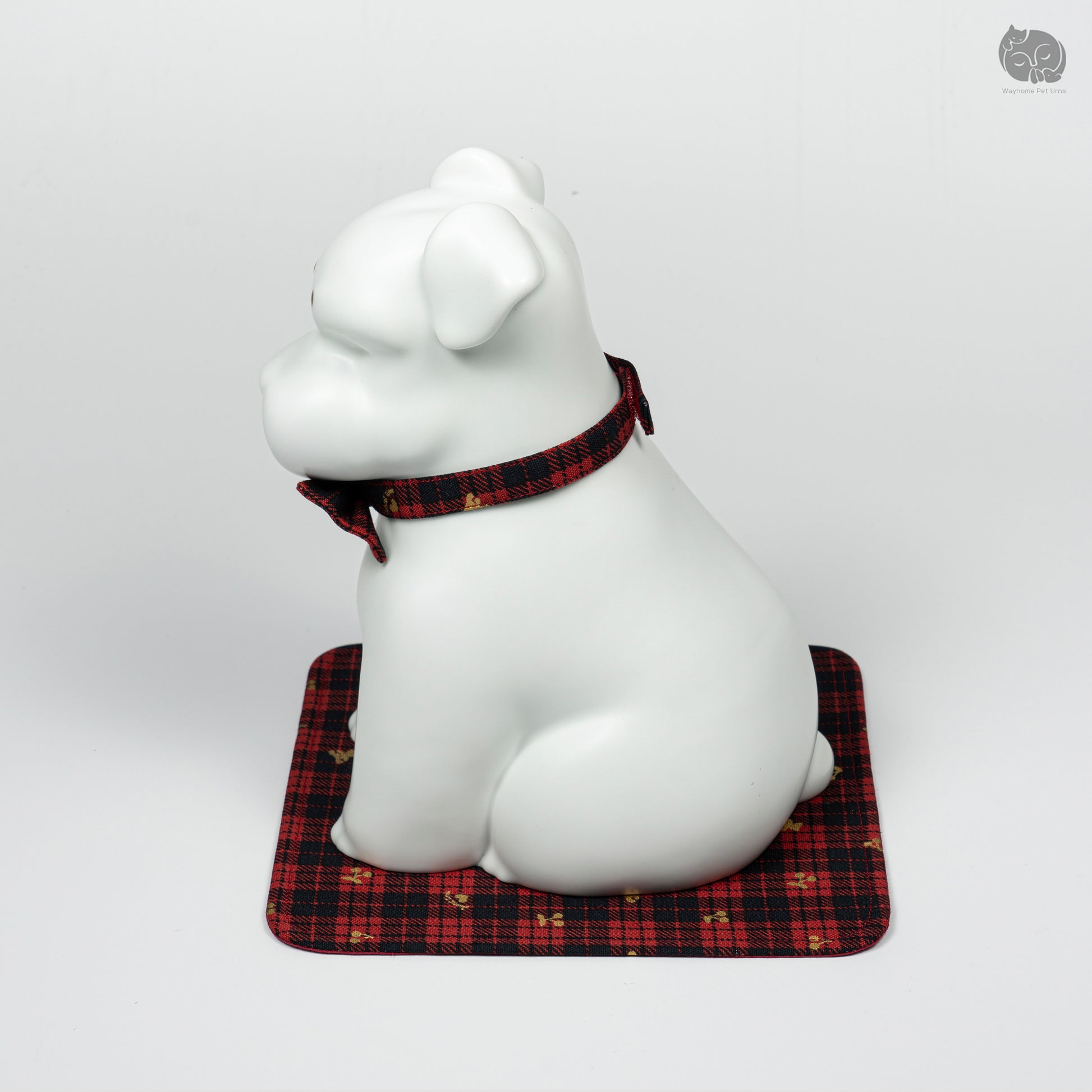 Side profile of the Wayhome white Terrier keepsake urn, highlighting the smooth ceramic finish and bow tie detail.