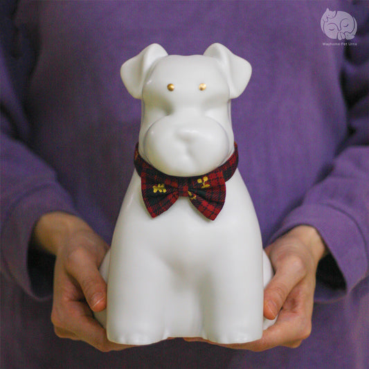 Wayhome ivory white ceramic dog urn for Terriers held in hands to show actual size and smooth artisan texture.